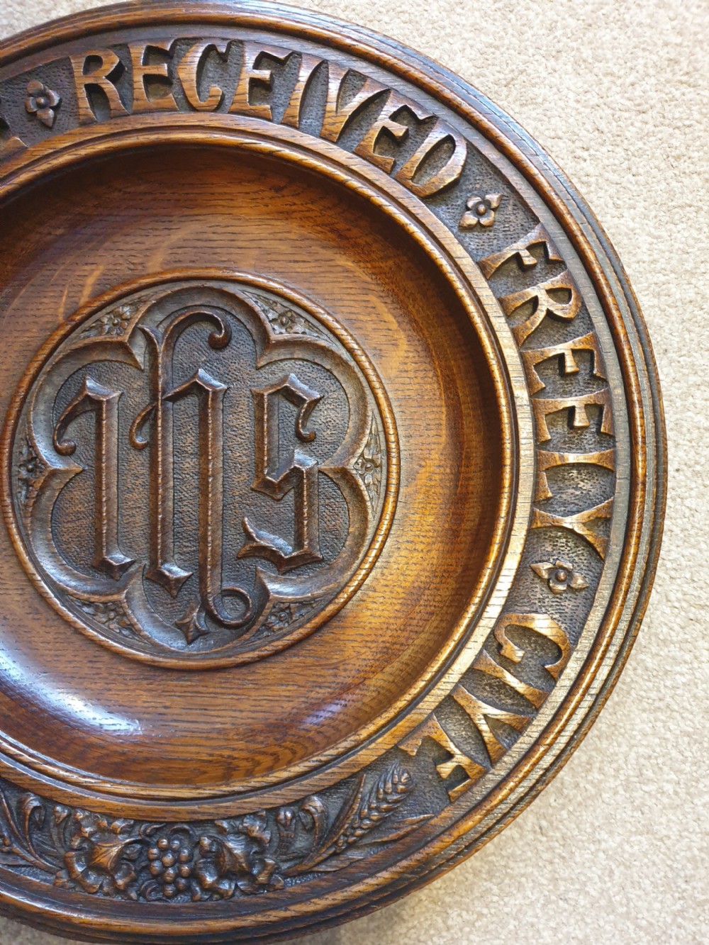 An finely carved and decorated oak alms dish  View III