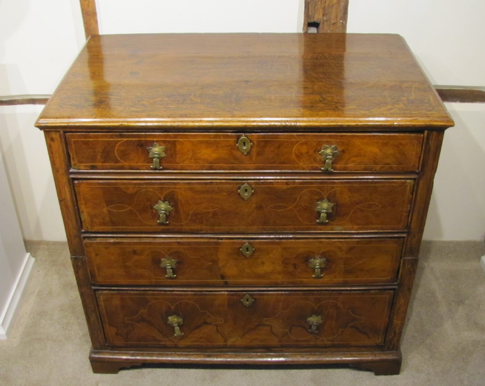 A William & Mary (Circa 1700) walnut and oak chest of drawers with original decorative inlay  View II