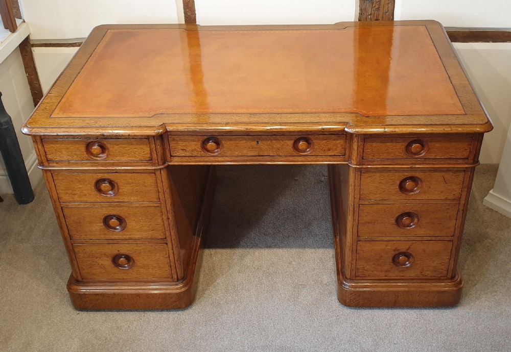 Late 19th Century oak pedestal desk with turned inset handles 