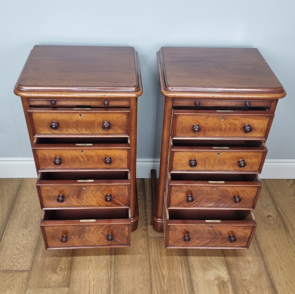 A fine pair of mahogany pedestal bedside chests with brushing slides View V