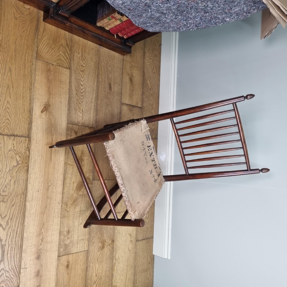 An antique dark wood Shaker rocking chair featuring a tall vertical spindle backrest, acorn finials, curved runners, and a purple upholstered seat. View IX