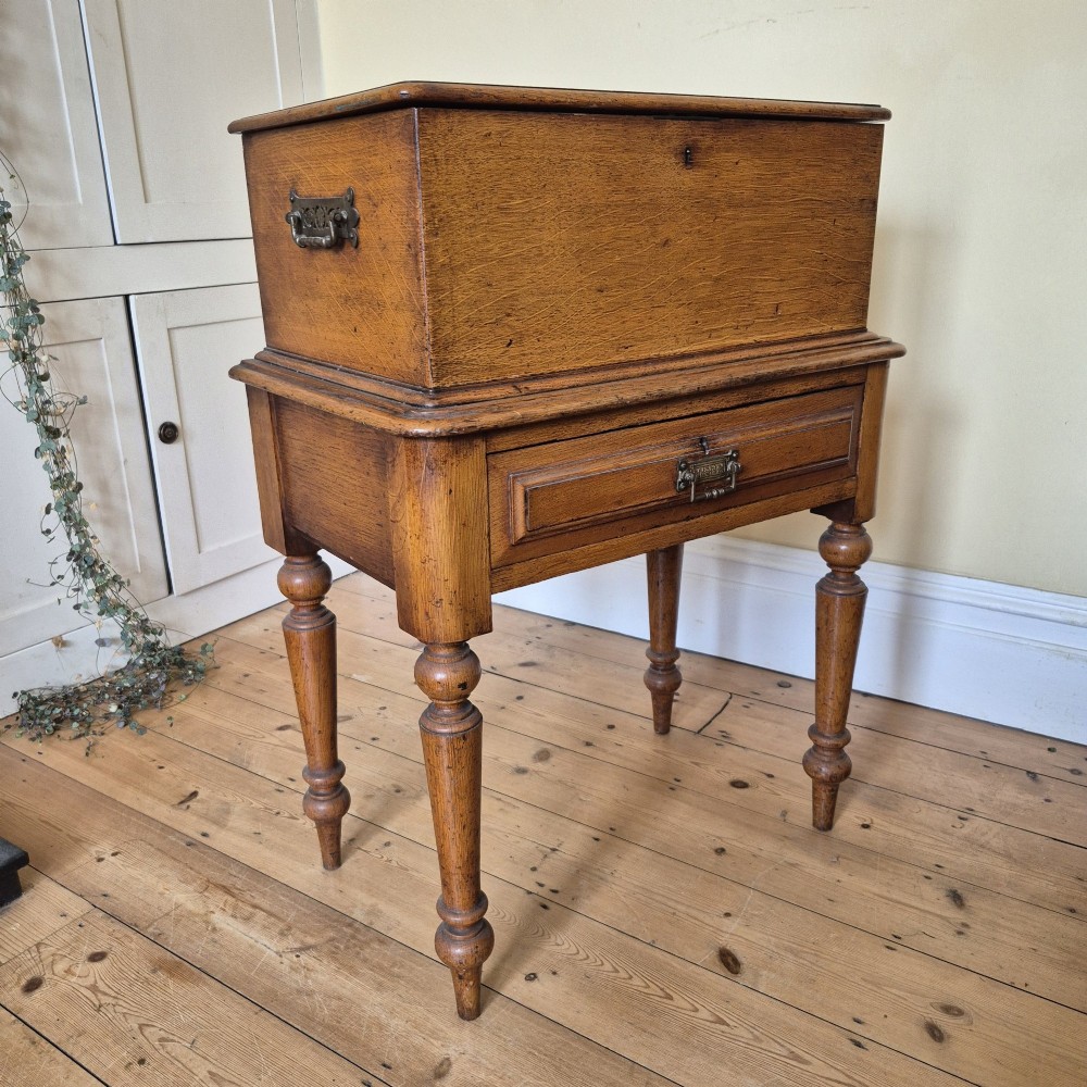A late 19th-century golden oak ticket collecting box with internal compartments set atop a matching turned-leg stand. View VIII
