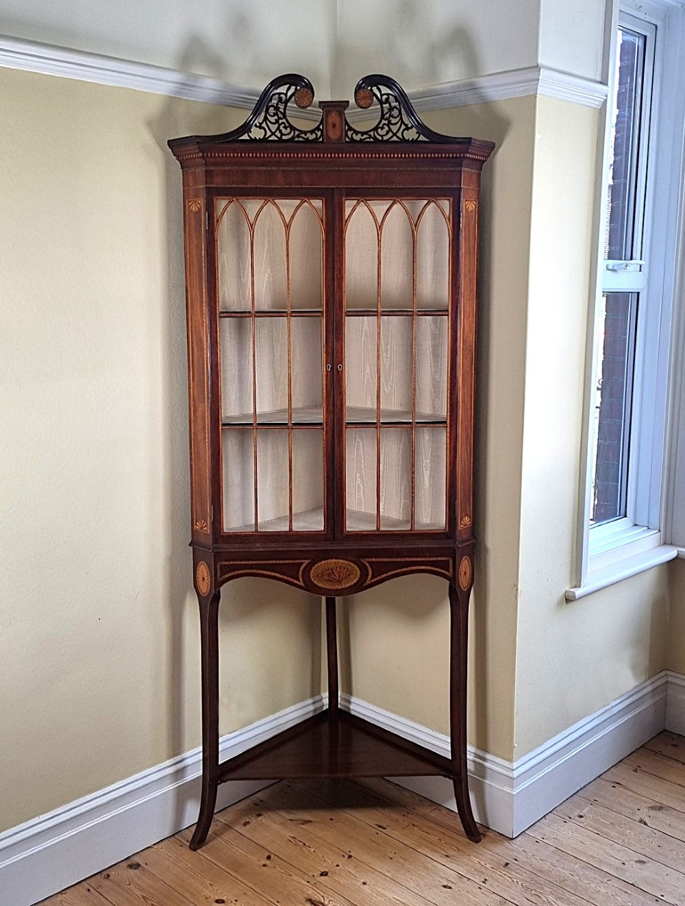 A fine Georgian glazed corner cabinet on stand