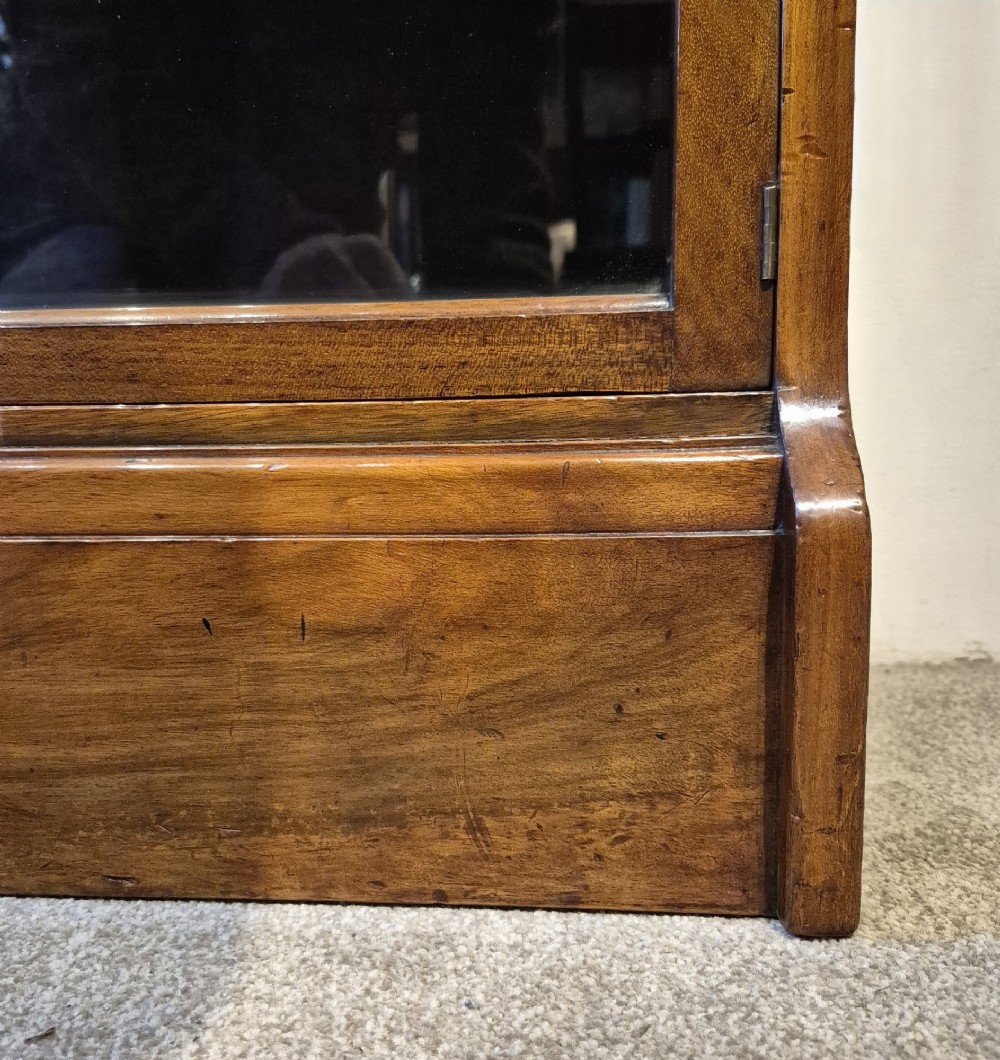A three-tier warm brown oak sectional bookcase with double glazed doors and brass ring handles. View X