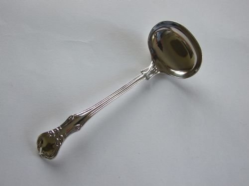 An Unusual Silver Cream Ladle in the Rare Victoria Pattern.