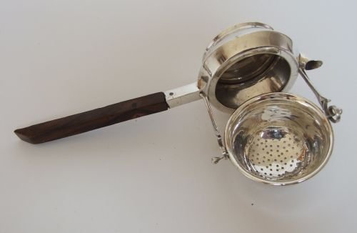 fig 1. A rare Asprey's patented silver teastrainer and drip cup.