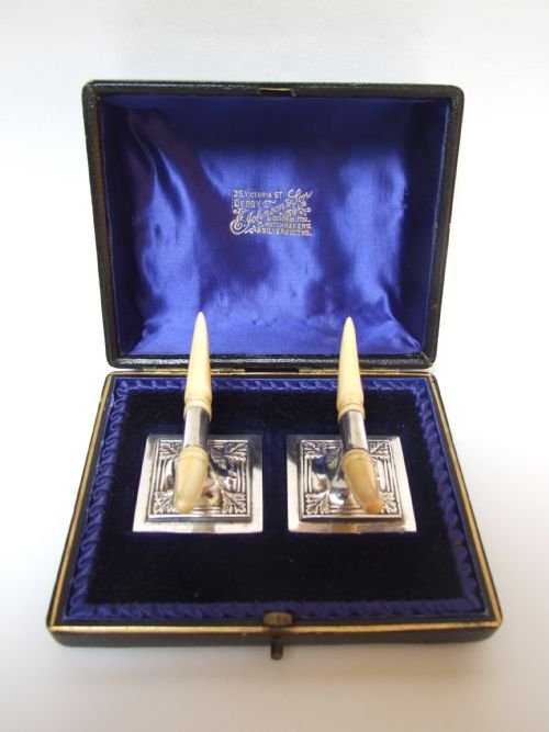 A Superb Quality Pair of Boxed Edwardian Silver and Ivory Knife/spoon Rests.