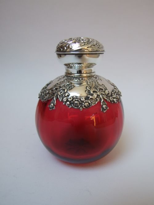 A Rare Edwardian Silver Shouldered and Lidded Cranberry Cologne Bottle.