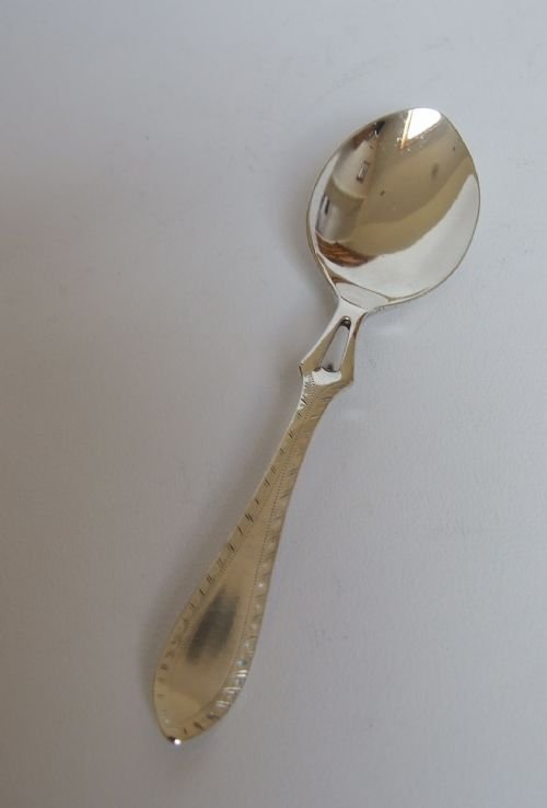 A Patented Design Silver Honey Spoon.
