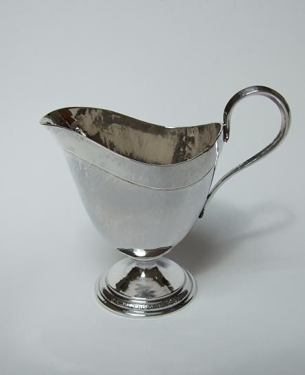 A Magnificent Omar Ramsden Planished Silver Cream Jug.