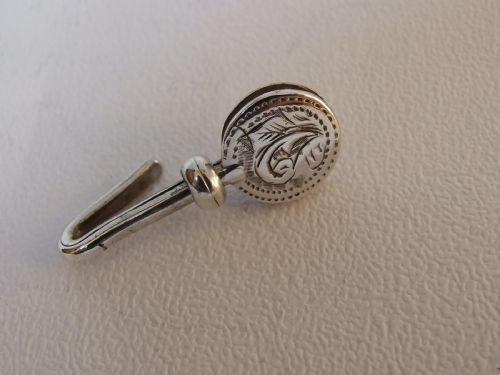 An Edwardian Engraved Silver Napkin Clip.