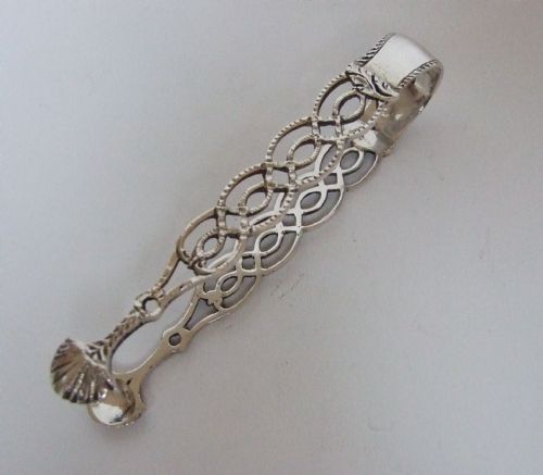 A Gorgeous Pair of Cast Silver Tongs in the Georgian Style.