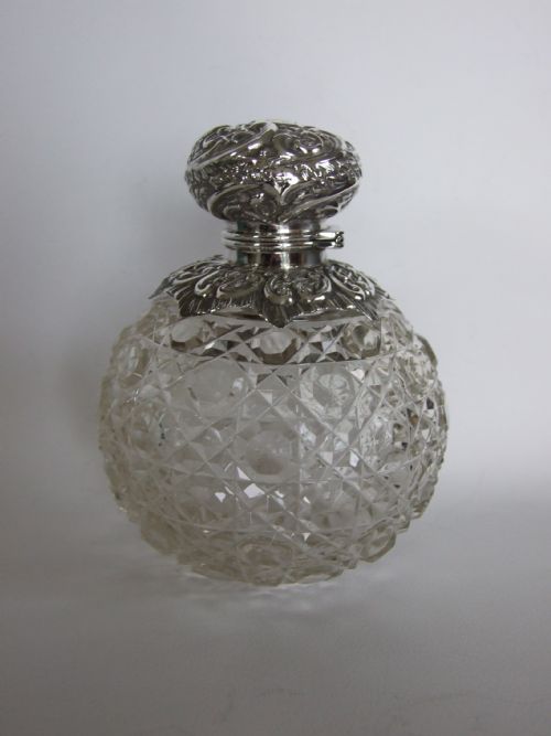 A Splendid Victorian Silver and Cut Glass Cologne Bottle.