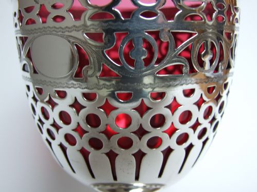 fig 1. A spectacular pierced silver sweetmeat basket with cranberry liner.