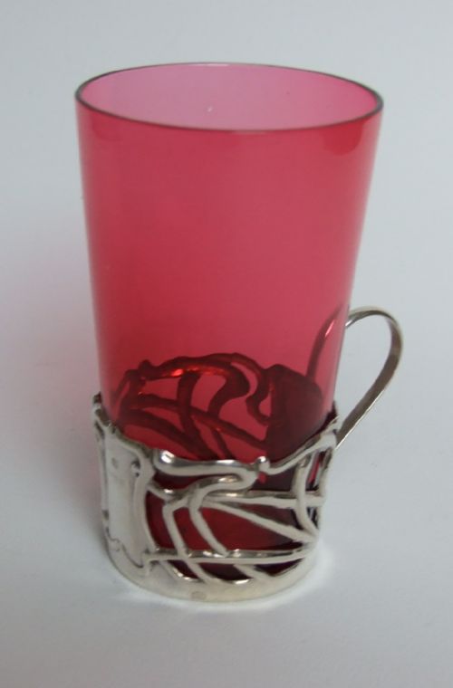A Lovely Art Nouveau Silver and Cranberry Holder and Beaker.