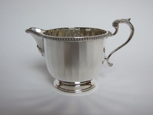 A Good Quality Panelled Silver Cream Jug.