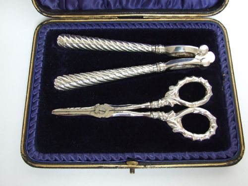 fig 1. A wonderful boxed set of silver handled nut crackers and grape shears.