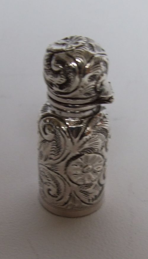 A Victorian All Silver Repousse Perfume Bottle.