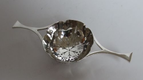 A Charming Twin Handled Silver Tea-strainer.