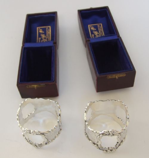 fig 1. A stunning pair of cast silver Edwardian napkin rings in boxes.