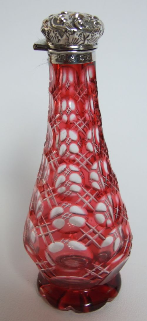 A Victorian Silver & Cranberry Gothic Perfume Bottle.
