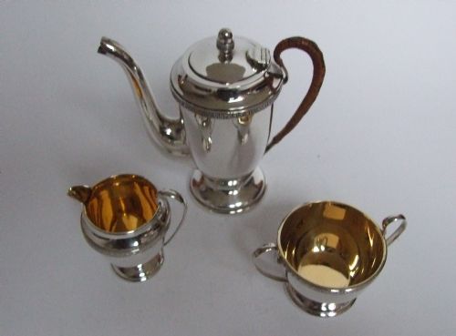 fig 1. An outstanding boxed silver cafe a deux with Royal Doulton coffee cans and silver spoons.