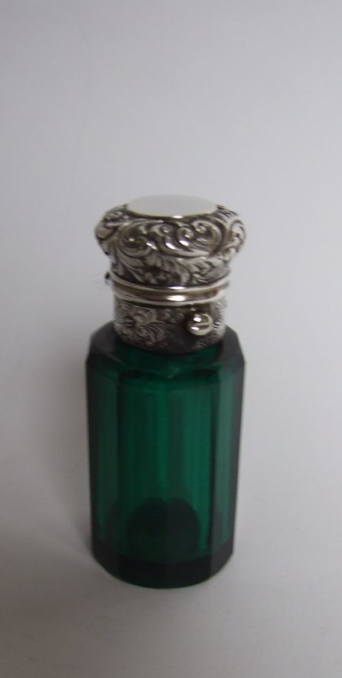 A Stunning Victorian Silver Mounted Perfume Bottle.
