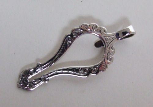 An Unusual Victorian Silver Napkin Clip.