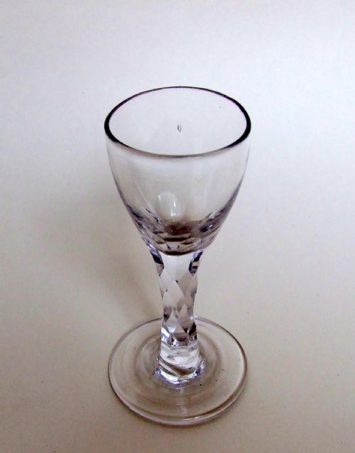 An 18th Century Cordial Glass with Facet Cut Stem.
