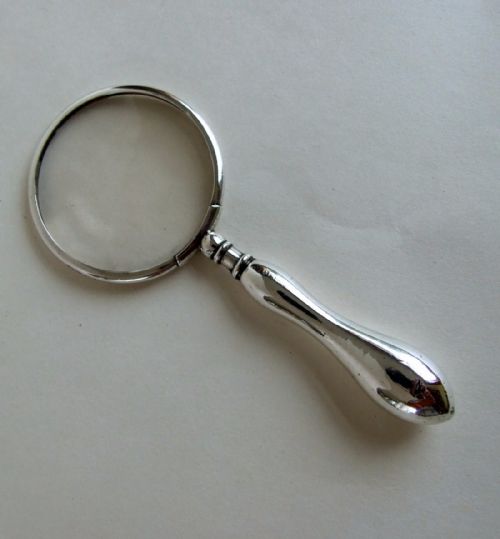fig 1. A silver framed magnifying glass from the First World War period.