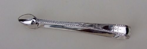 A Gorgeous Pair of 18th Century Bright Cut Silver Tongs.