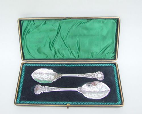 A Pair of Boxed Victorian Silver Plated Preserve Spoons.
