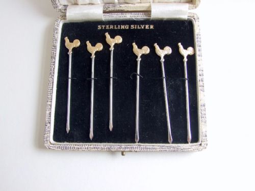 fig 1. A rare set of Sterling silver gilt cockerel cocktail sticks in the original box.