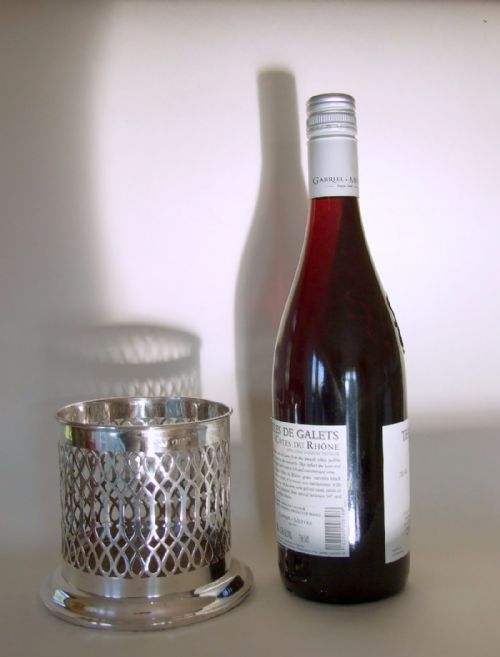 A Charming George V Pierced Silver Wine Bottle Coaster.