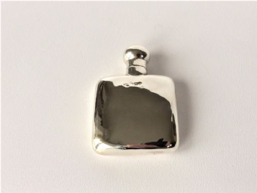fig 1. A small 'one tot' silver hip flask.