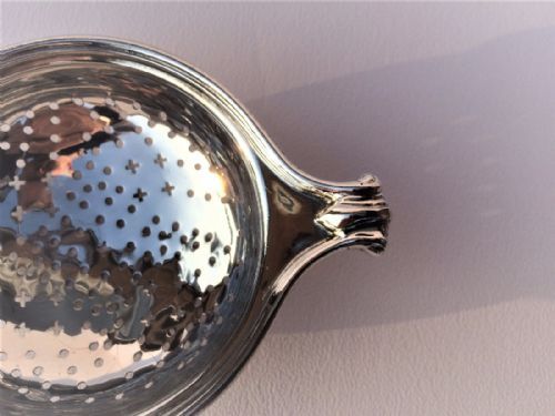 fig 1. A rare Onslow pattern cast silver tea strainer.