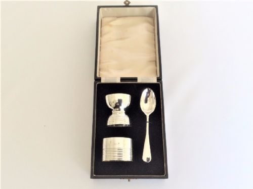 An Art Deco Boxed Silver Egg Cup, Spoon & Napkin Ring.