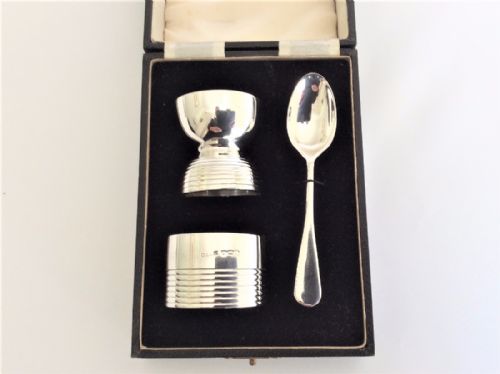fig 1. An Art Deco boxed silver egg cup, spoon & napkin ring.