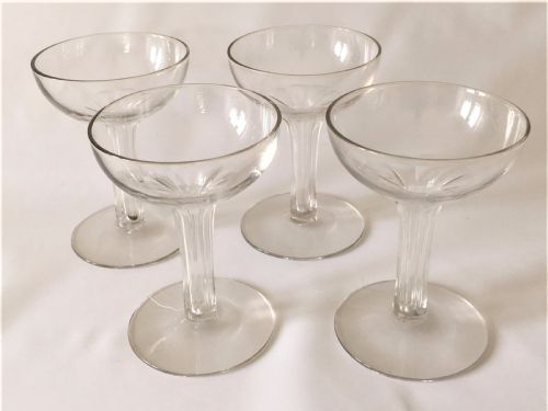 A Set of Four Small Hollow Stem Champagne Glasses.