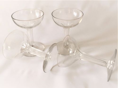 fig 1. A set of four small hollow stem champagne glasses.