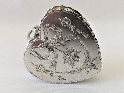 fig 1. An engraved silver heart shaped pillbox.