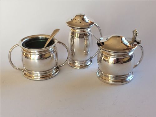 A Stylish Silver Cruet with Green Liners and Spoons
