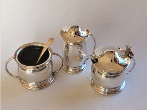 fig 1. A stylish silver cruet with green liners and spoons