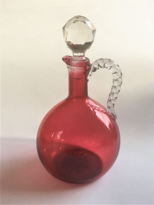 A Victorian Cranberry Wine Jug with Barley Twist Handle