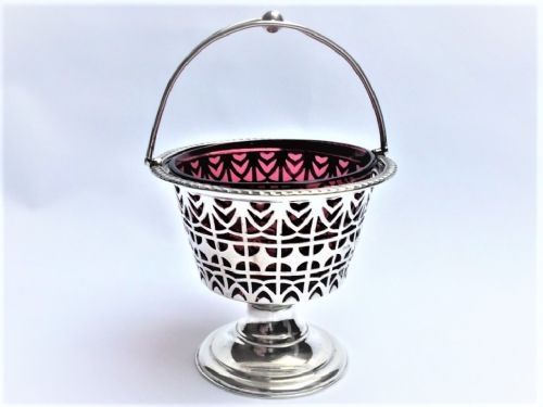 fig 1. An Edwardian silver and cranberry swing handle basket.