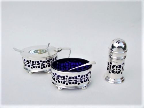 fig 1. A pierced silver three piece cruet and spoons