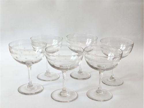 A Set of Six Star Etched Champagne Glasses