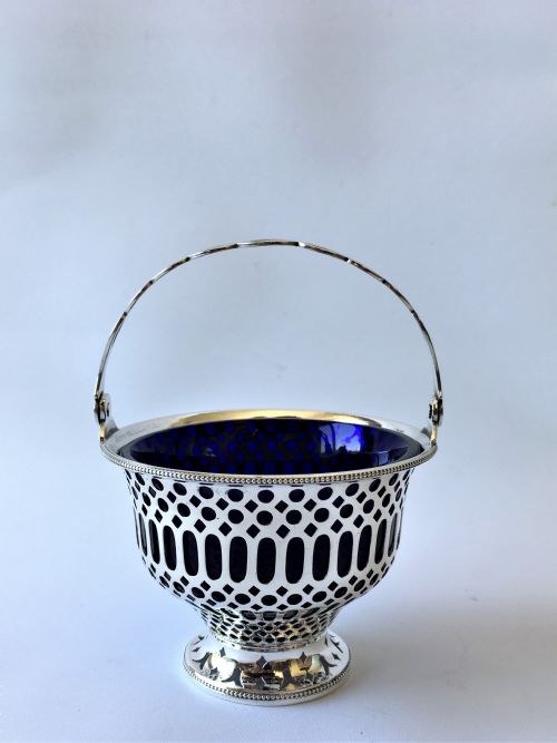 fig 1. An Edwardian pierced silver swing handled bonbon basket