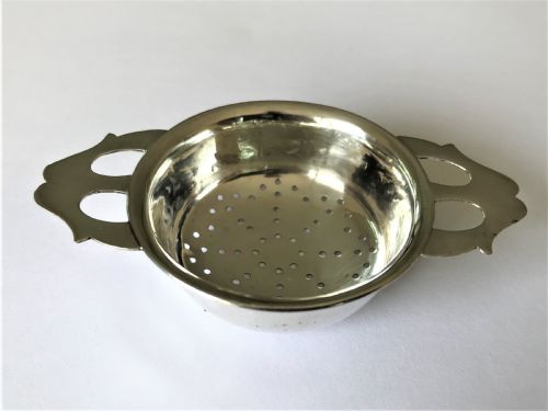 fig 1. A stylish silver tea strainer in the Art Nouveau style