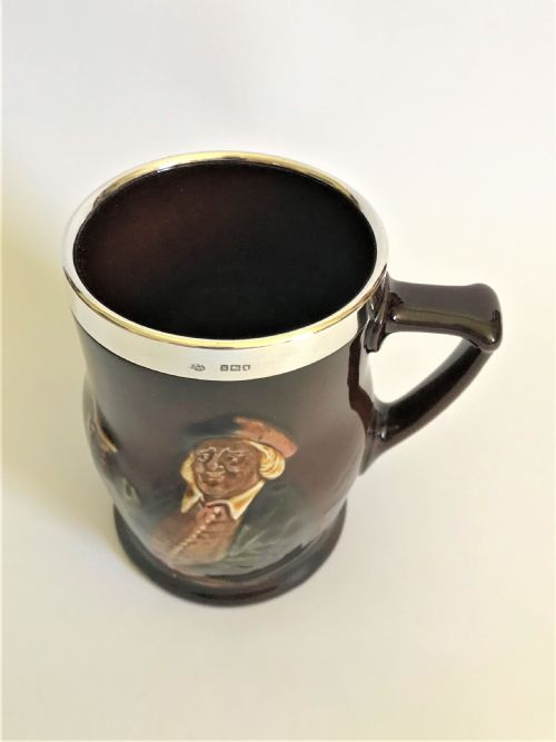 fig 1. An Edwardian silver mounted Royal Doulton tankard